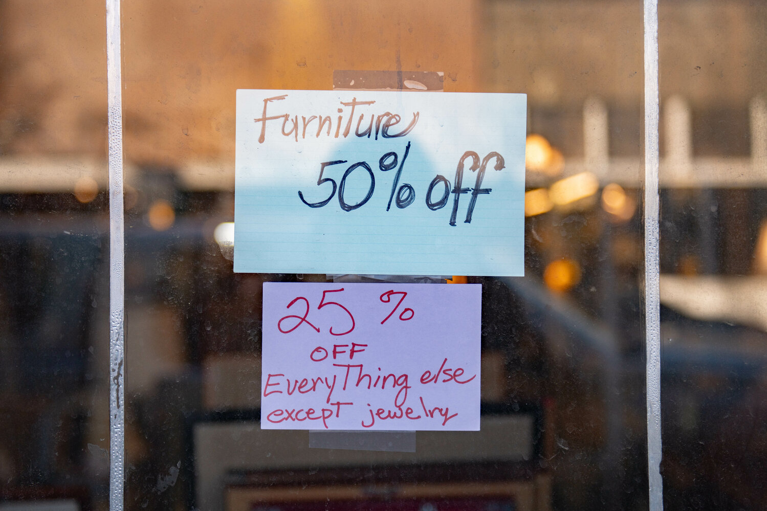Discount sale signs are displayed outside of Pacific Coin & Collectibles and Alivia's Attic in downtown Centralia on Feb. 23.
