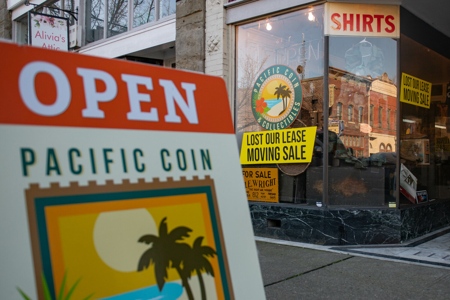 Moving sale signs are displayed outside of Pacific Coin & Collectibles and Alivia's Attic in downtown Centralia on Feb. 23.